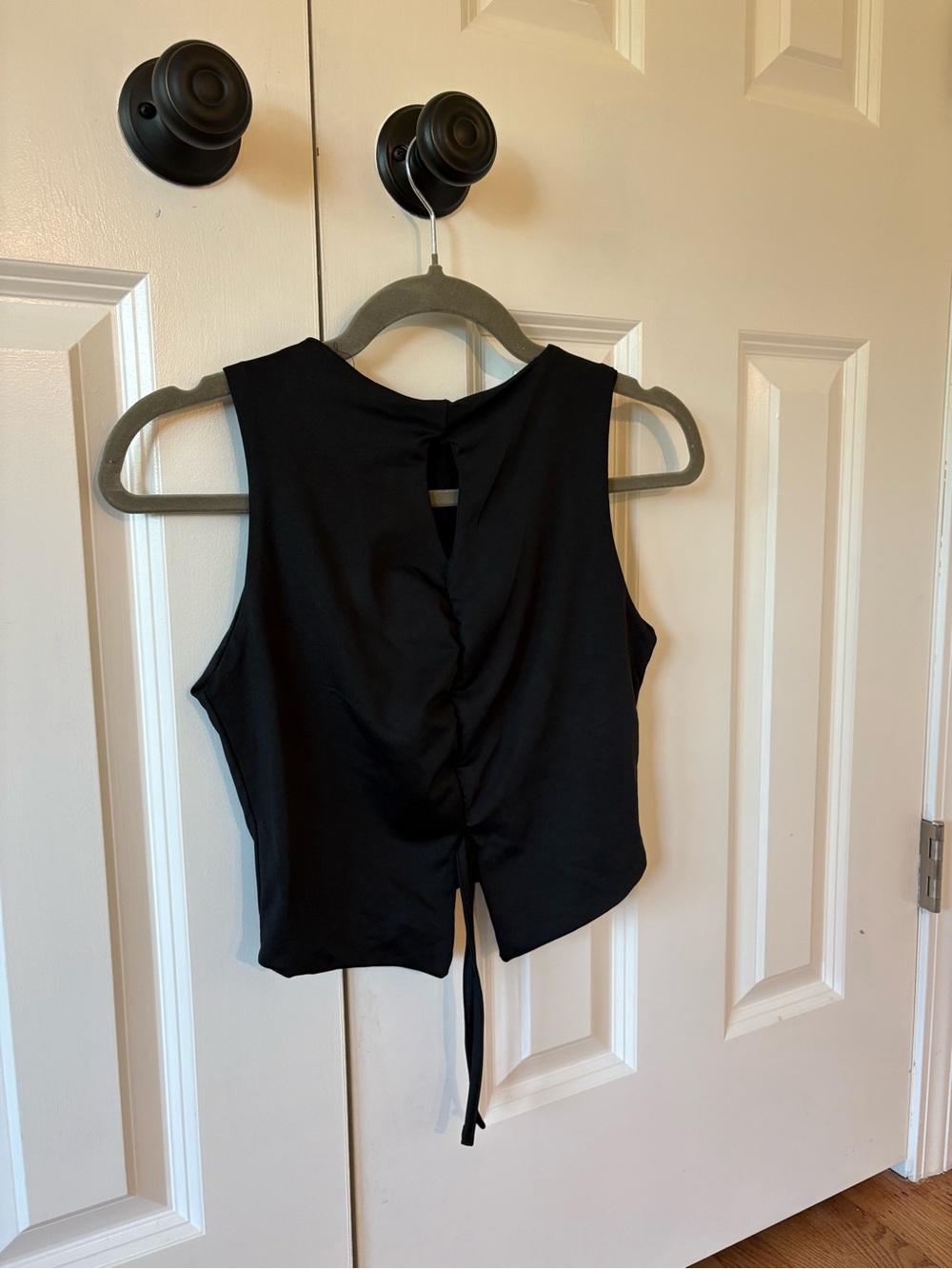 Sleeveless black crop top.